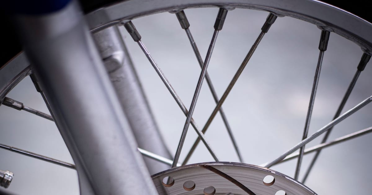 A motorcycle front wheel with its brake disc.