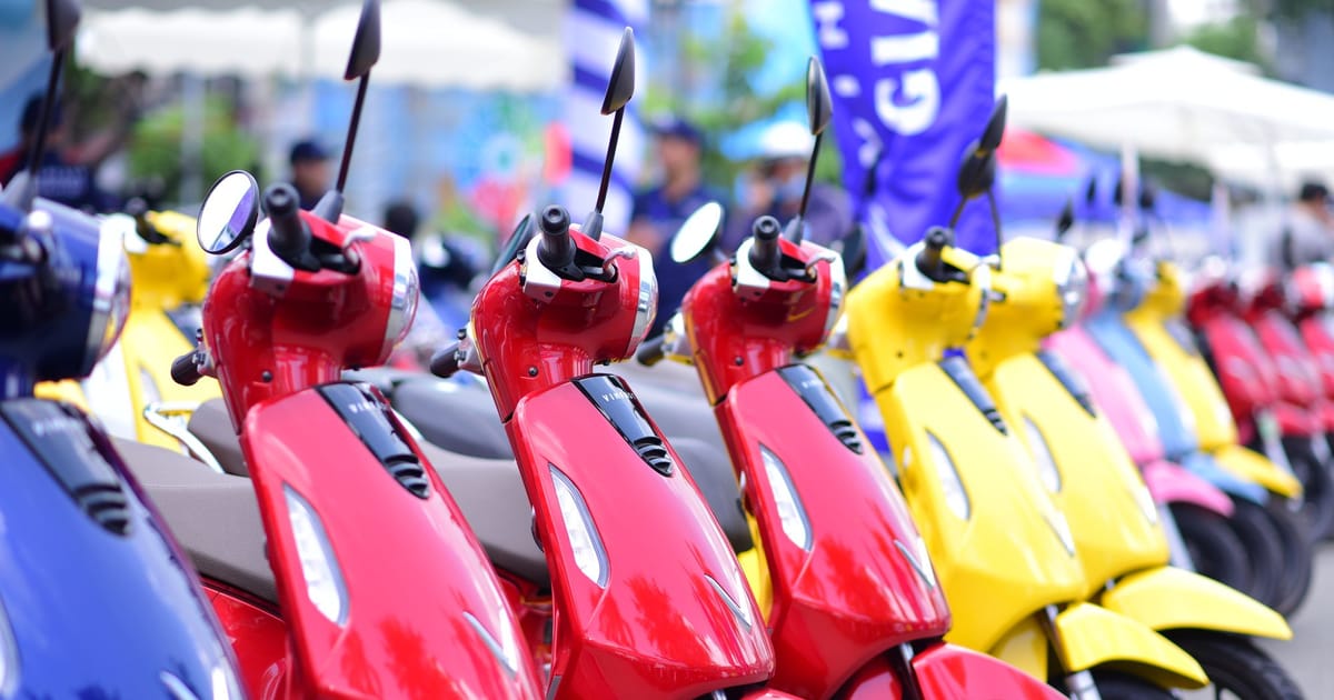 Rows of new scooters lined up at an outdoor display.